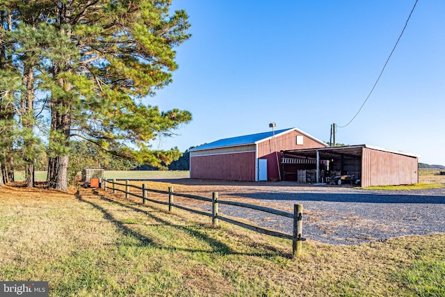 view of outdoor structure with a yard and a rural view