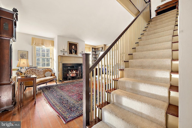 stairs featuring hardwood / wood-style floors