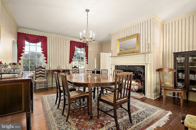 dining area with ornamental molding, plenty of natural light, and dark wood-type flooring