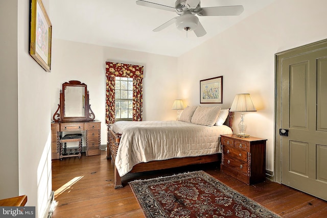 bedroom with dark hardwood / wood-style flooring and ceiling fan