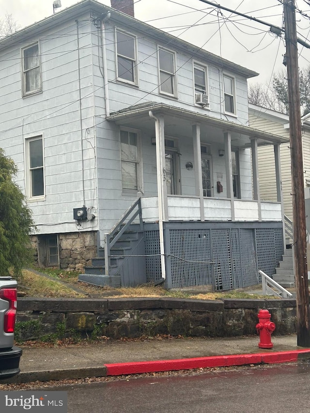 view of front facade featuring cooling unit and a porch