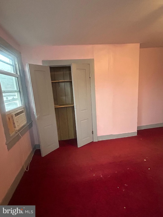 unfurnished bedroom with carpet flooring and cooling unit