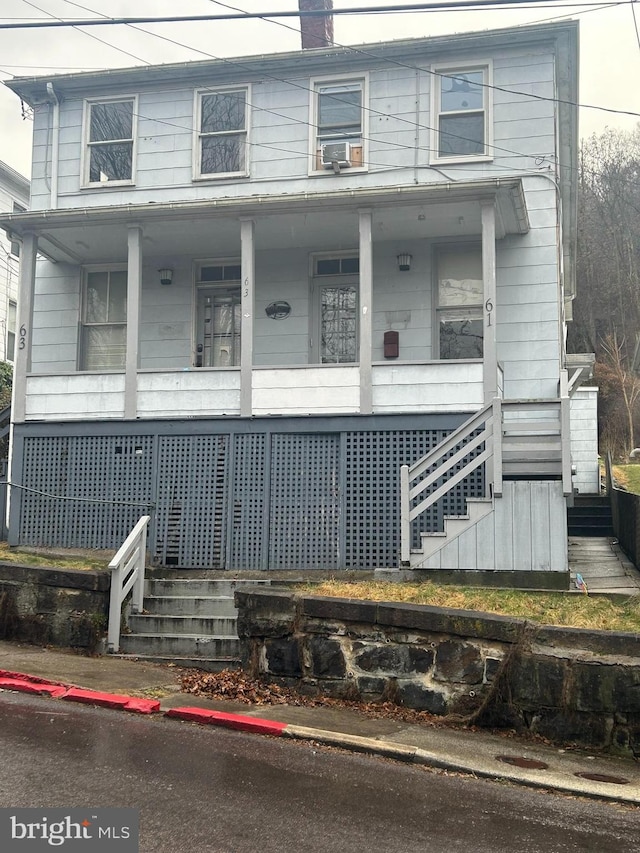 view of front facade with cooling unit and covered porch