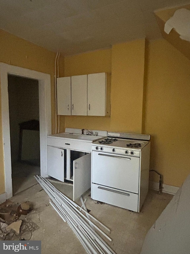 kitchen with white cabinetry and white gas range oven