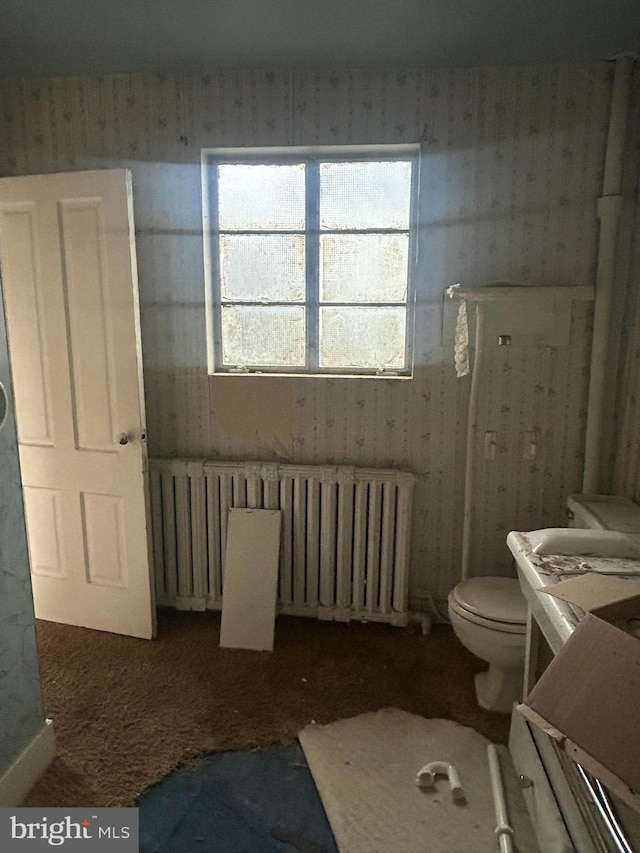 bathroom featuring toilet and radiator