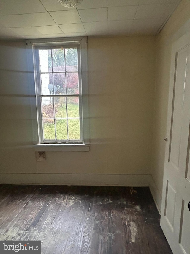 unfurnished room featuring dark hardwood / wood-style flooring