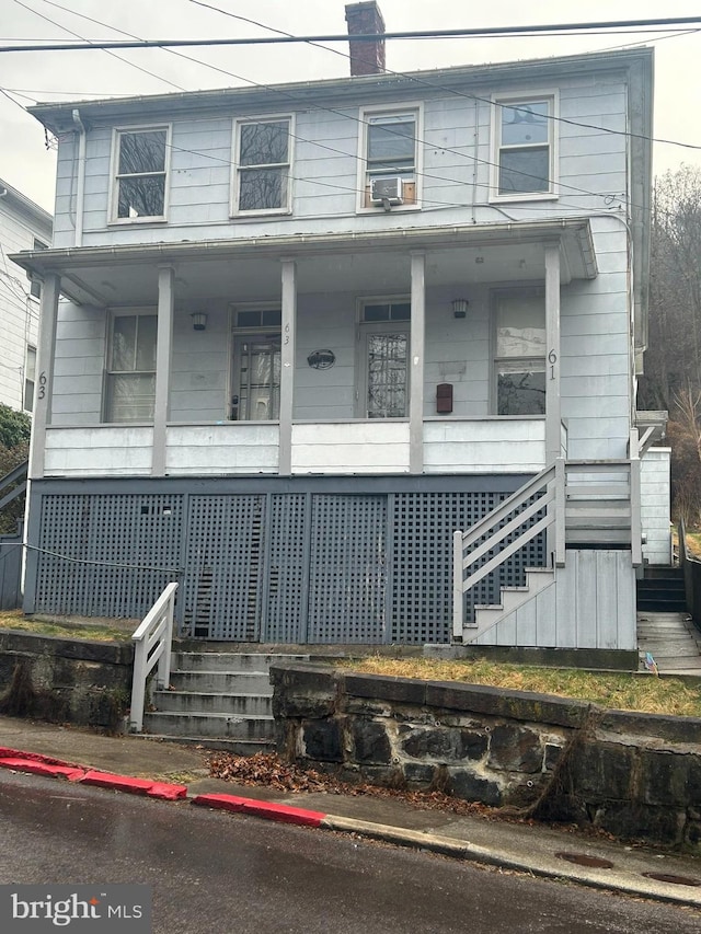 view of front of property featuring a porch and cooling unit