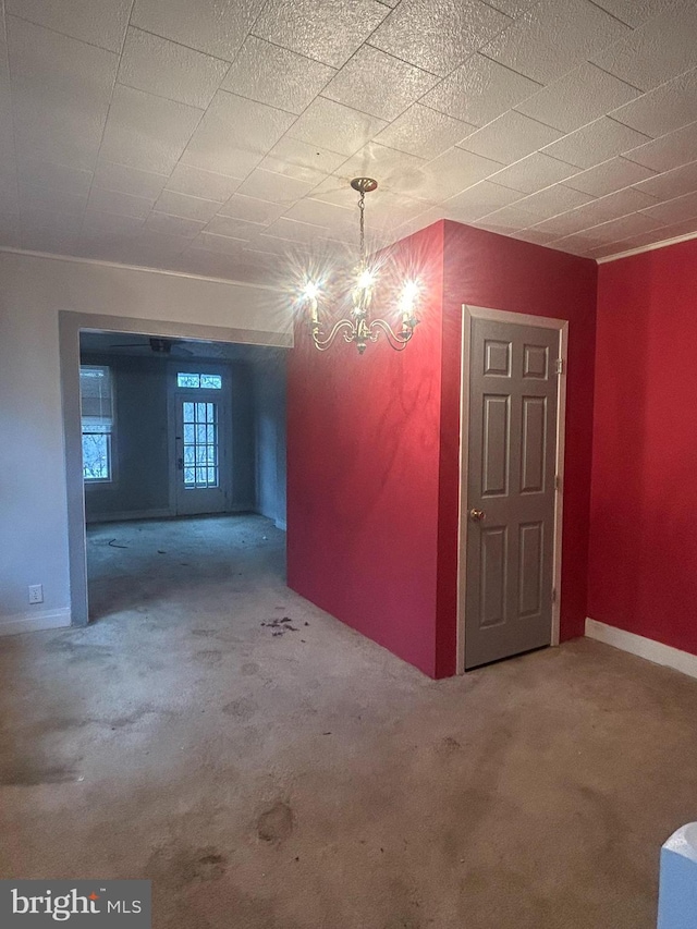 basement featuring carpet floors and an inviting chandelier