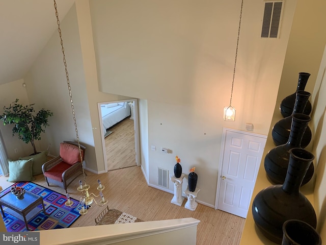 living room featuring light wood-type flooring and vaulted ceiling