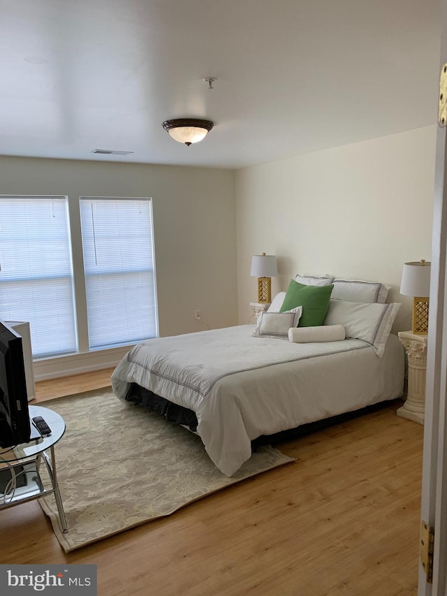 bedroom with hardwood / wood-style flooring