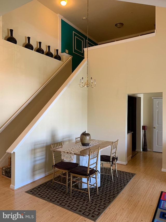 dining area featuring hardwood / wood-style flooring and an inviting chandelier