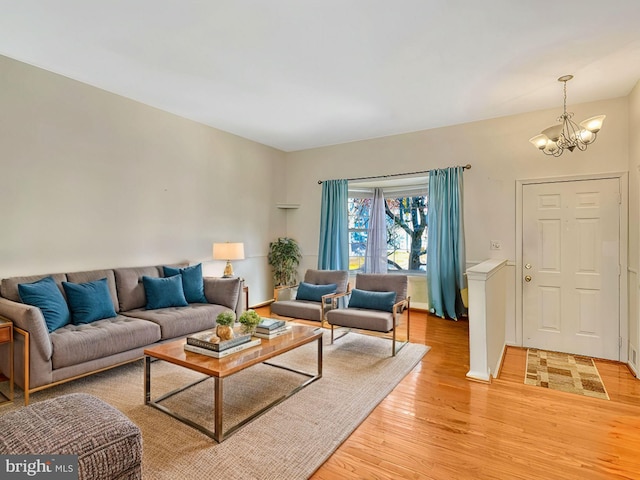 living room featuring a notable chandelier and light hardwood / wood-style floors