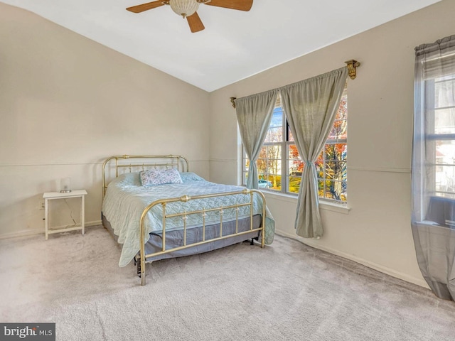 carpeted bedroom featuring ceiling fan and lofted ceiling