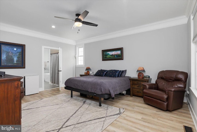 bedroom with light wood-type flooring, ensuite bathroom, ceiling fan, and ornamental molding