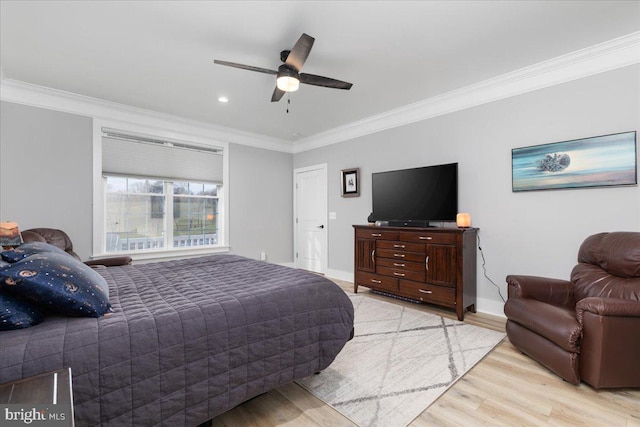 bedroom with ceiling fan, light hardwood / wood-style floors, and ornamental molding