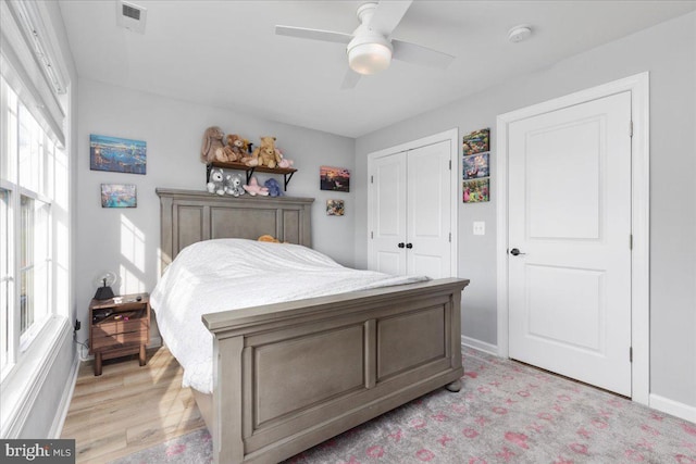 bedroom featuring a closet, ceiling fan, and light hardwood / wood-style flooring