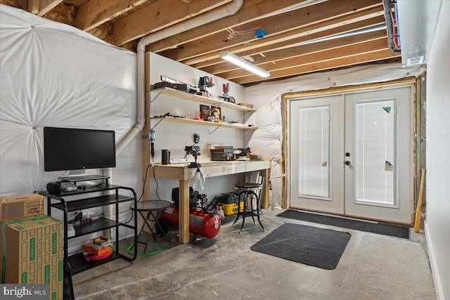 basement featuring a workshop area and french doors