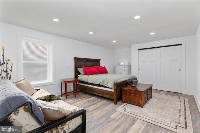 bedroom featuring a closet and light wood-type flooring