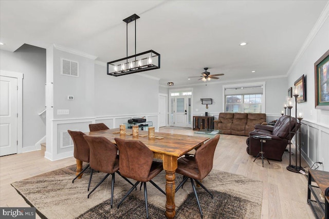 dining area with ceiling fan, light hardwood / wood-style flooring, and ornamental molding