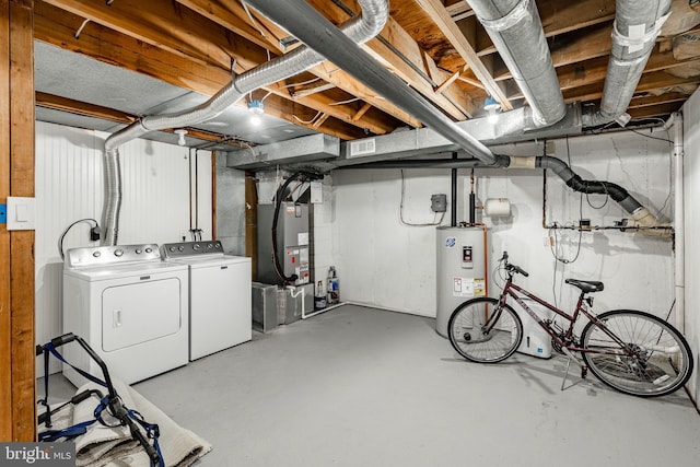 basement with electric water heater, separate washer and dryer, and heating unit