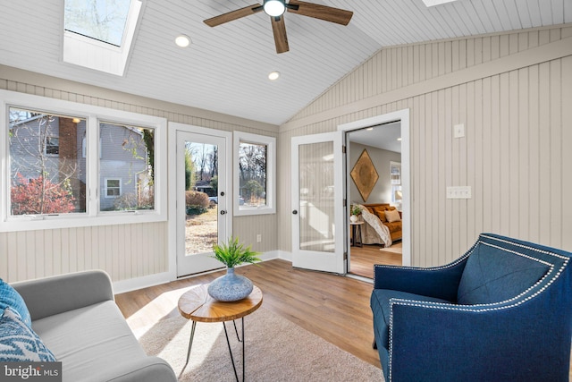 sunroom / solarium with french doors, lofted ceiling with skylight, and ceiling fan