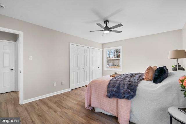 bedroom with ceiling fan, light wood-type flooring, and a closet