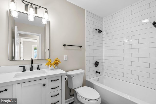 full bathroom with vanity, tiled shower / bath combo, and toilet