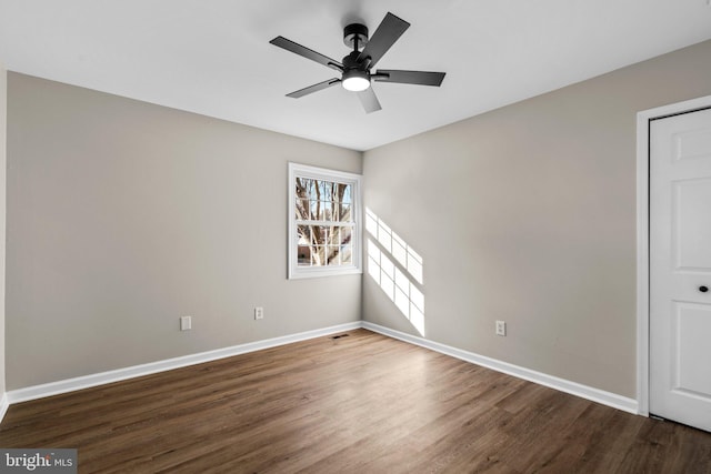 unfurnished room featuring dark hardwood / wood-style floors and ceiling fan