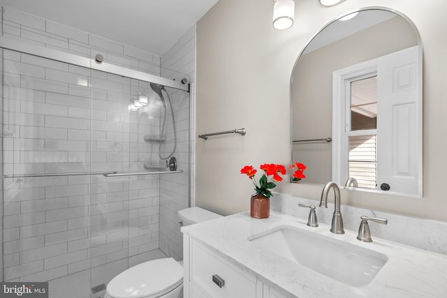 bathroom with vanity, toilet, and an enclosed shower