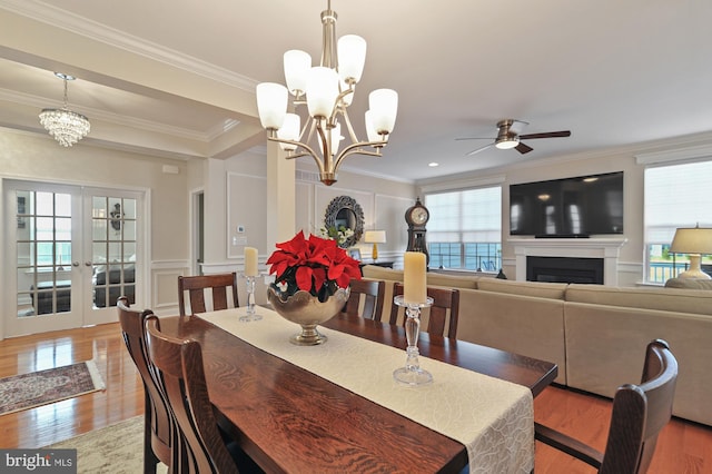 dining room with ceiling fan, french doors, crown molding, and light hardwood / wood-style flooring