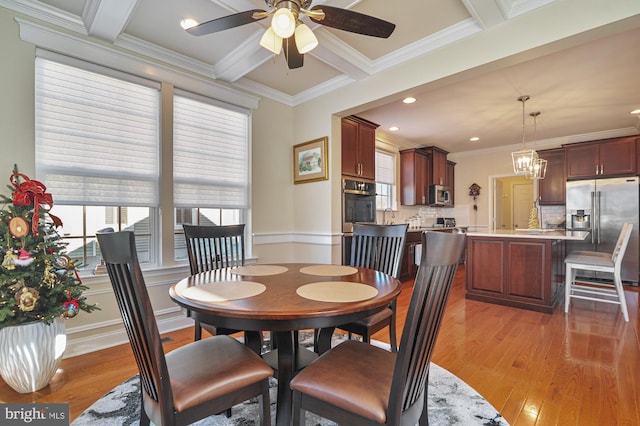 dining area with beamed ceiling, wood-type flooring, ceiling fan with notable chandelier, and ornamental molding