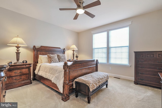 bedroom with ceiling fan and light carpet