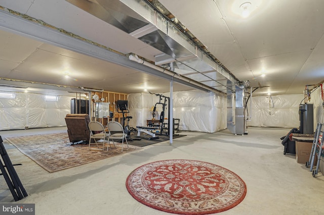 basement featuring gas water heater and heating unit