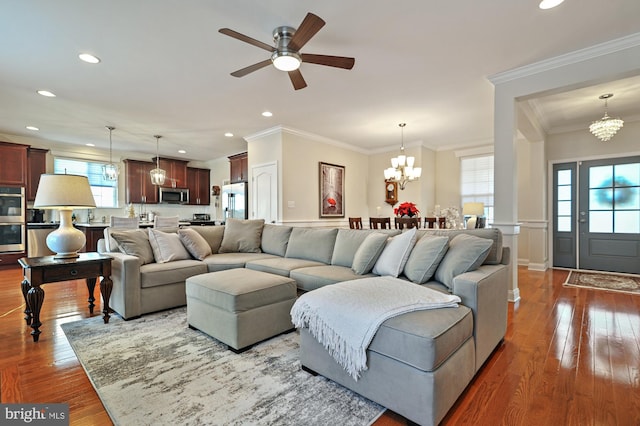 living room featuring a healthy amount of sunlight, crown molding, and wood-type flooring