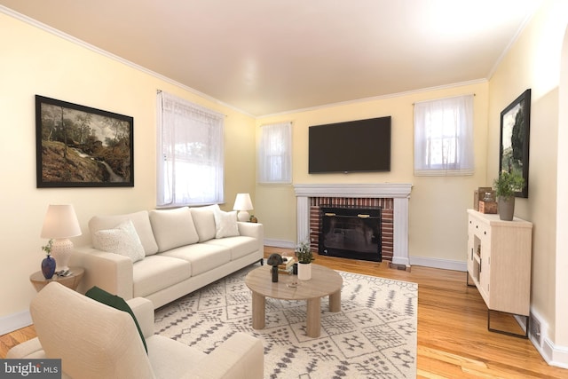 living room featuring crown molding, wood finished floors, baseboards, and a wealth of natural light