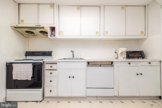 kitchen with a sink, under cabinet range hood, white appliances, white cabinets, and light countertops