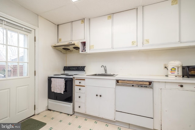 kitchen with under cabinet range hood, a sink, white cabinetry, white appliances, and light countertops