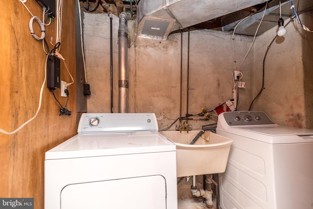 clothes washing area featuring laundry area and washer and clothes dryer