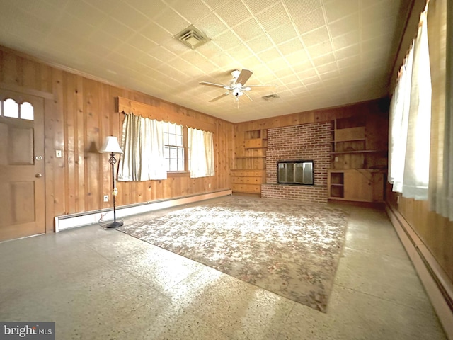 unfurnished living room with ceiling fan, baseboard heating, and a brick fireplace