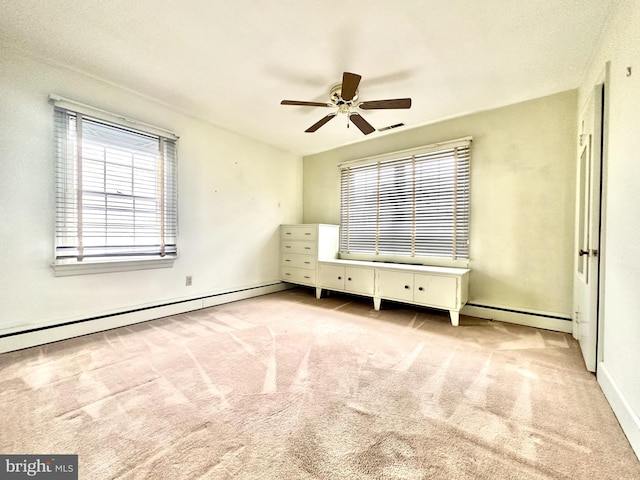 unfurnished bedroom with light carpet, a baseboard radiator, and ceiling fan