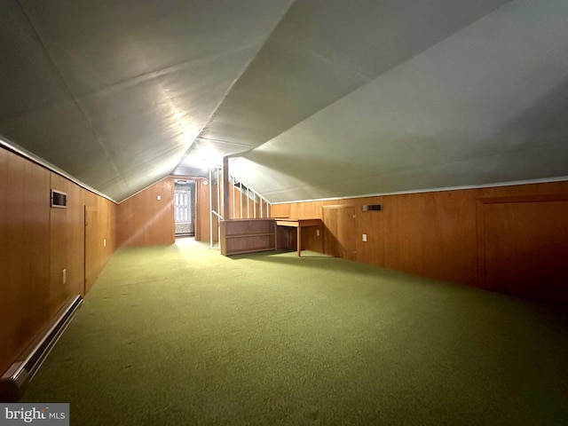 bonus room featuring carpet flooring, a baseboard heating unit, lofted ceiling, and wooden walls