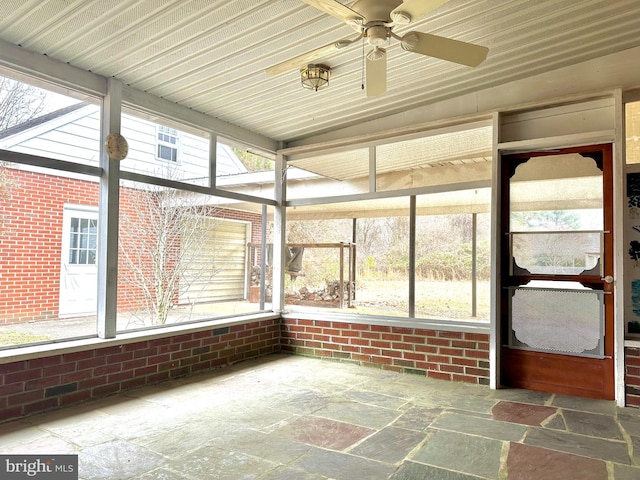 unfurnished sunroom featuring ceiling fan