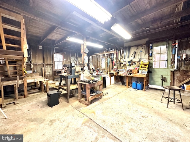 misc room featuring a workshop area and concrete flooring