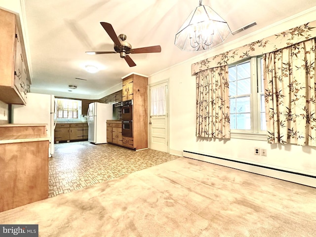 interior space with carpet flooring, a baseboard heating unit, ceiling fan with notable chandelier, and crown molding