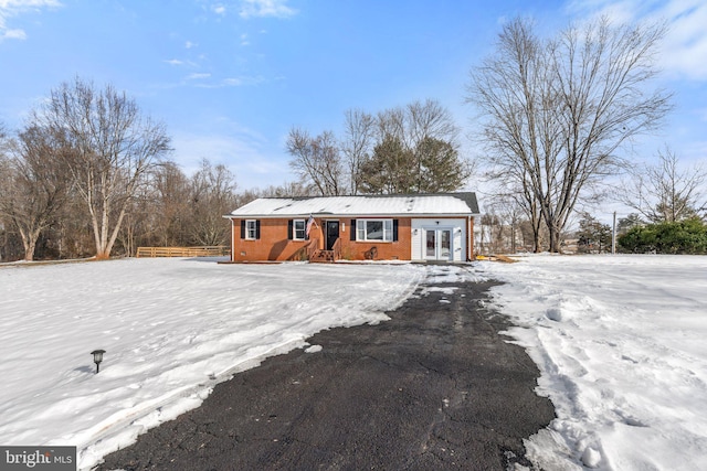 snow covered property with french doors