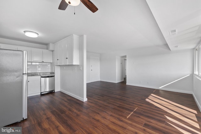 kitchen with white cabinets, dark hardwood / wood-style floors, stainless steel dishwasher, and fridge