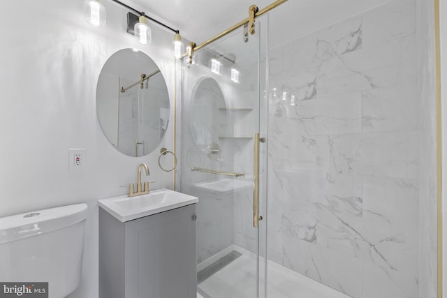 bathroom featuring vanity, toilet, and an enclosed shower