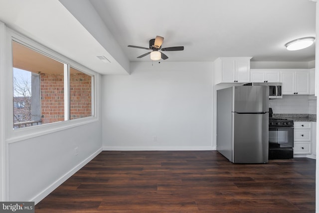 kitchen with dark hardwood / wood-style floors, ceiling fan, decorative backsplash, white cabinetry, and stainless steel appliances