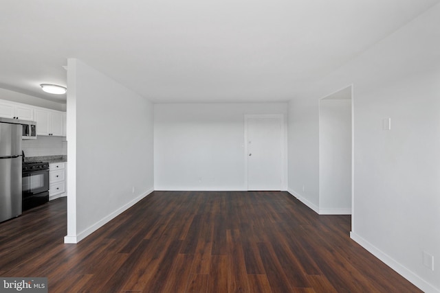 unfurnished room with dark wood-type flooring