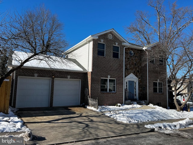 traditional home with a garage, brick siding, and driveway